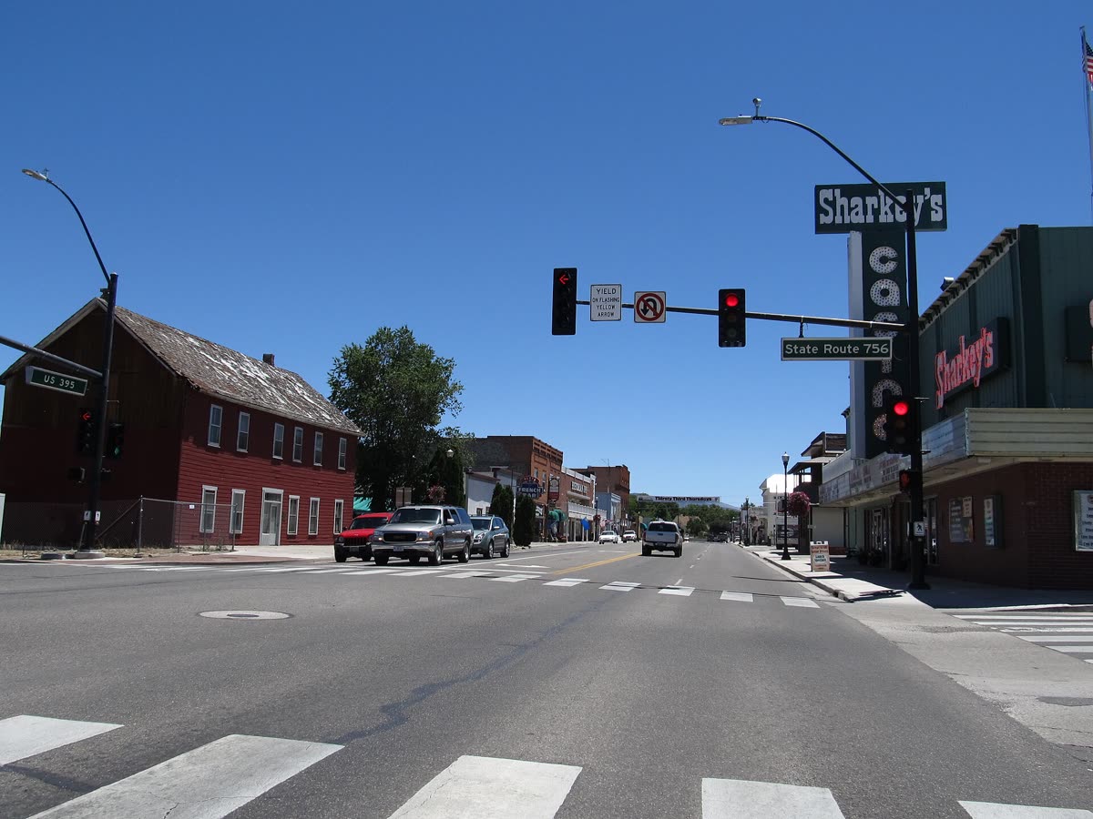 A street in downtown Gardnerville with a red brick building and a Sharkey's sign