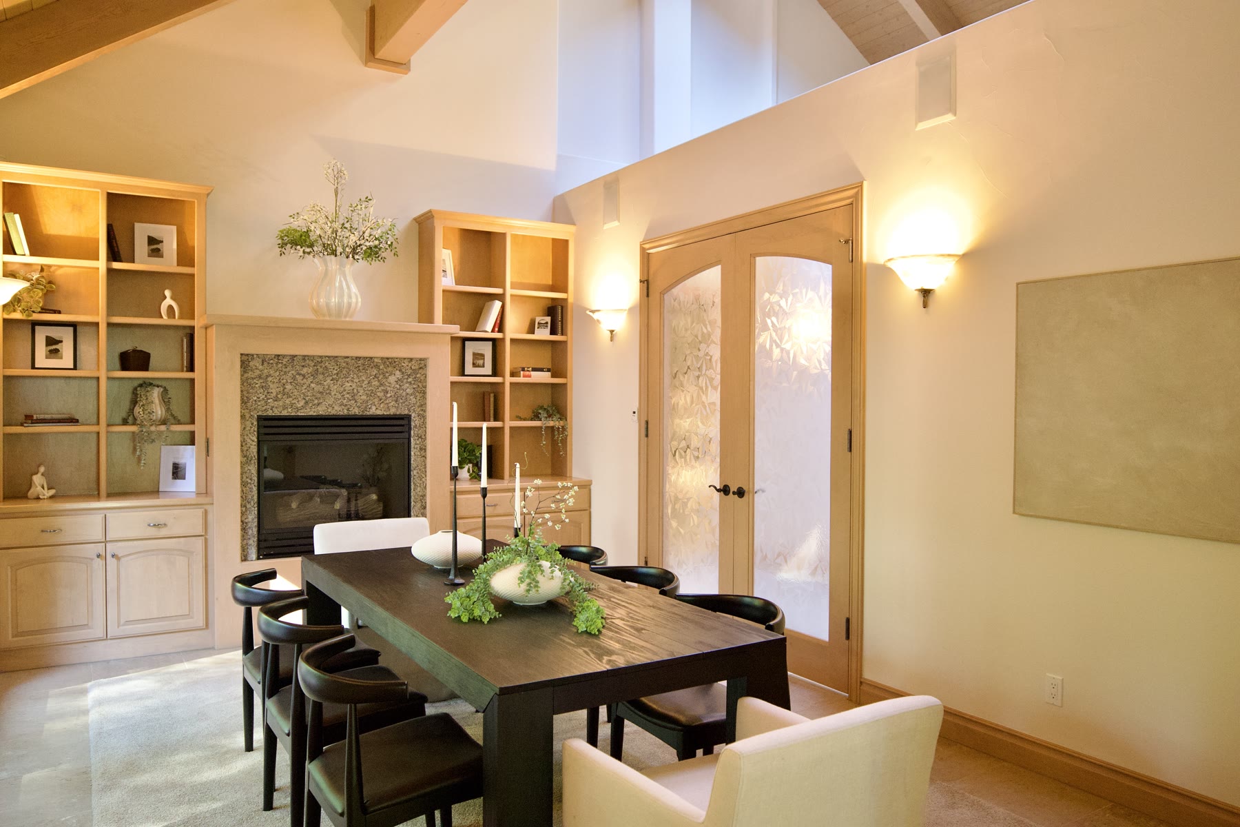Staged dining room with a dark table and styled built-in shelves
