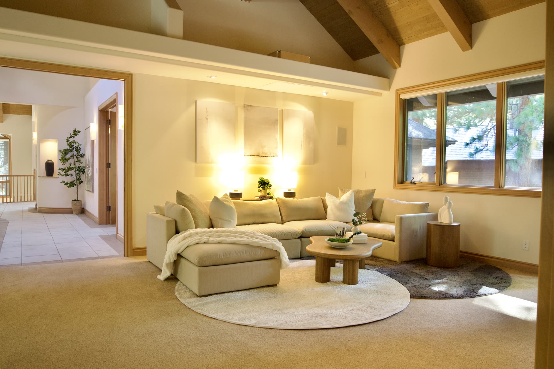 Staged family room with a sectional, round rug and lamps