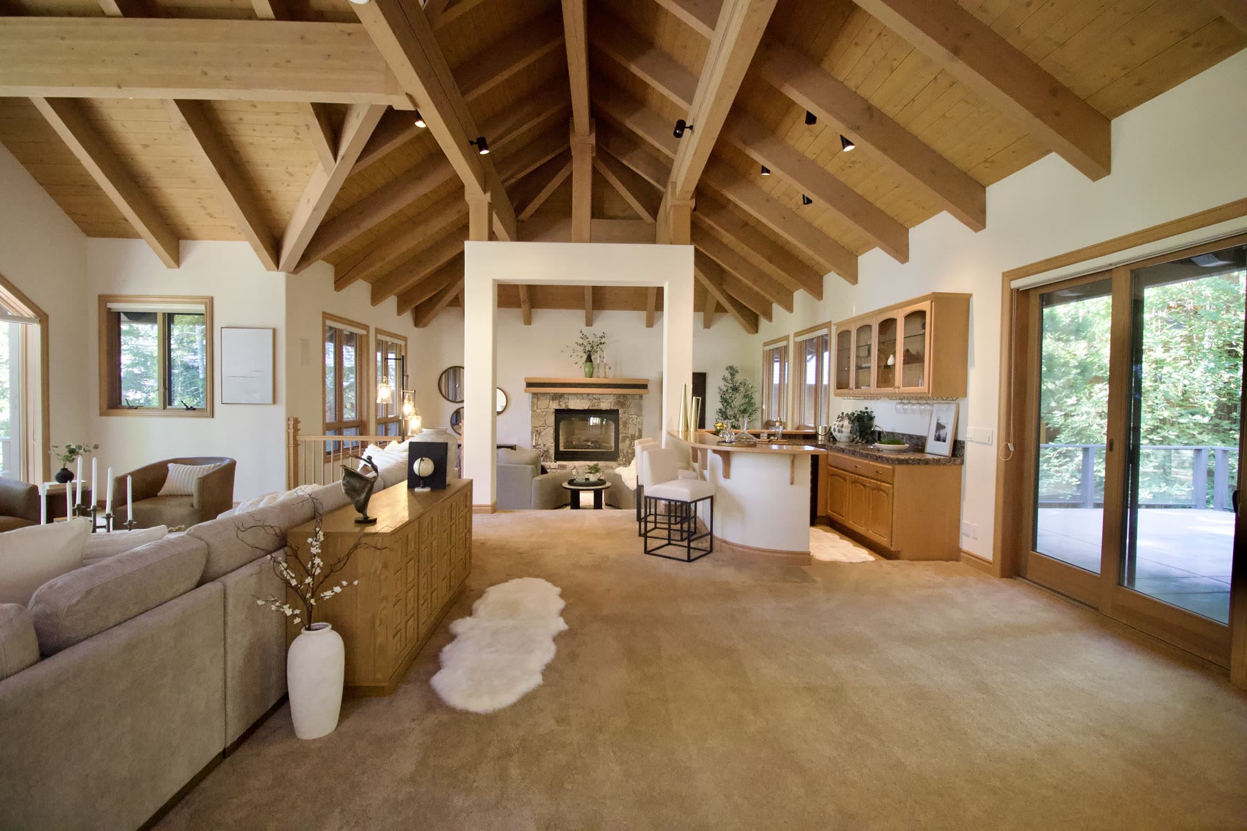 Staged great room with vaulted wood-beam ceiling